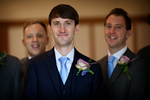 Groom with blue tie and rose buttonhole