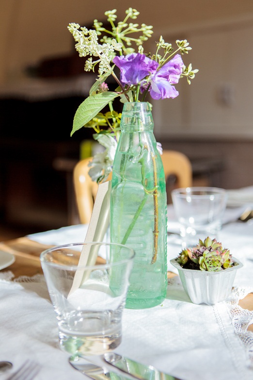 Vintage green glass bottle with flowers