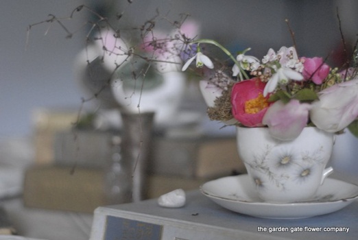 Teacup of dreamy romantic spring wedding flowers
