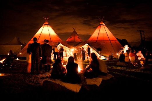 Giant tipis lit up at night