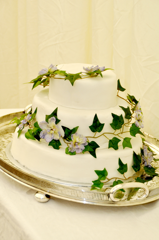 Wedding cake with delphinium flowers and ivy