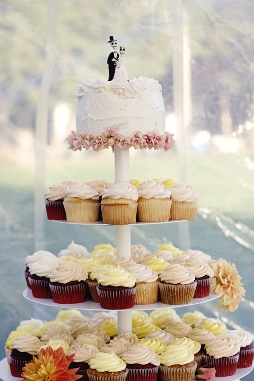 Cupcake wedding cake with 'day of the dead' cake topper - photography http://www.redanchorphoto.com/