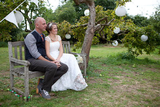 Outdoor wedding ceremony beneath a tree - Photography by www.david-owens.co.uk