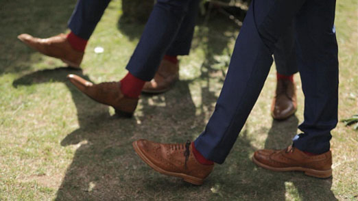 Groomsmen in navy suits with red socks – photography http://www.brightstarfilms.co.uk/
