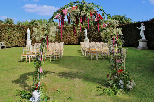 Floral wedding ceremony arch with amaranthus