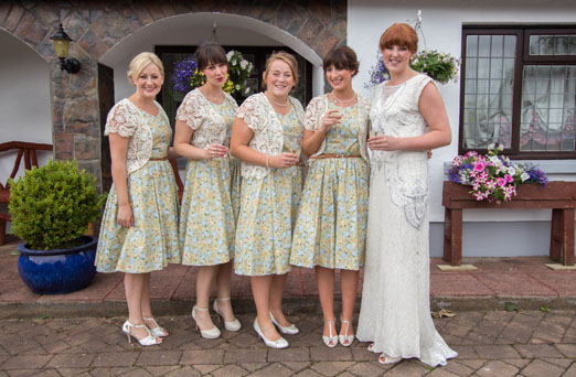 Bride in a handmade beaded wedding dress and bridesmaids wearing floral 1950s inspired dresses // The Natural Wedding Company