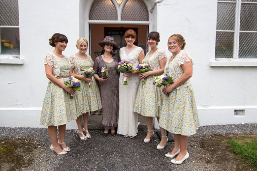 Bride in a handmade beaded wedding dress and bridesmaids wearing floral 1950s inspired dresses // The Natural Wedding Company