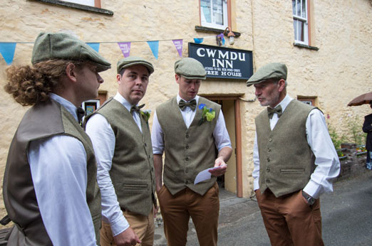 Country groom and groomsmen in waistcoats and flat caps // The Natural Wedding Company