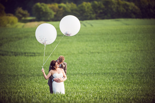Bride and groom with giant white balloons // photography www.andyhook.com/ 