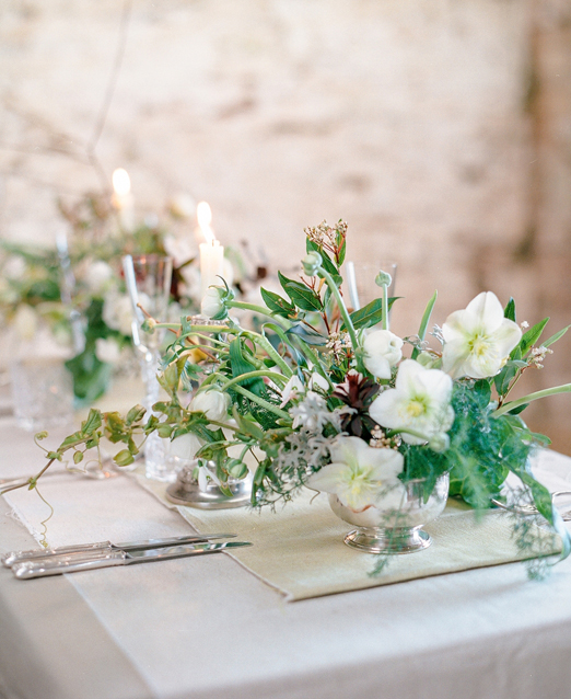 Elegant winter wedding table arrangements of hellebores, ivy and mixed foliage // The Garden Gate Flower Company // Taylor & Porter Photographs