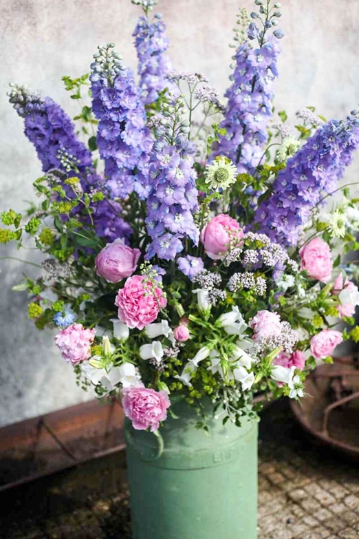 Seasonal summer milk churn arrangement of Delphiniums, peonies and euphorbia by Green and Gorgeous Flowers // The Natural Wedding Company