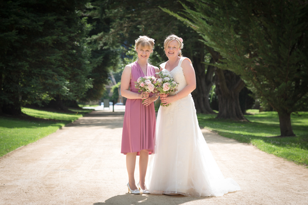 Country bride with bridesmaid in pink // Photography Belinda McCarthy // The Natural Wedding Company