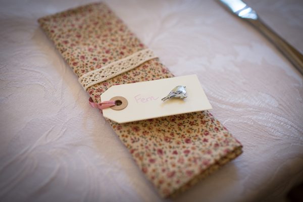 Floral wedding napkins with bird pin wedding favours // Photography Belinda McCarthy // The Natural Wedding Company