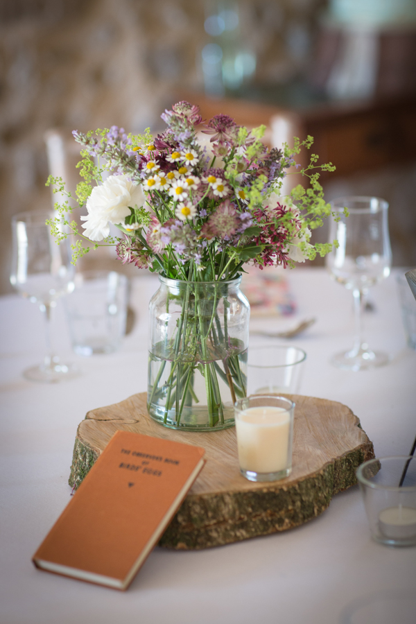 Country flower, log and vintage book table centre // Photography Belinda McCarthy // The Natural Wedding Company