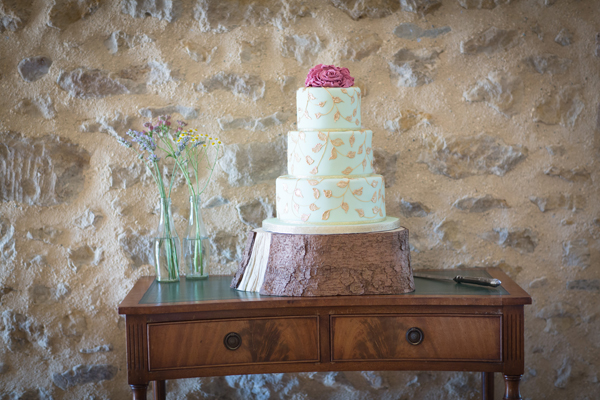 Turquoise, pink and gold wedding cake on a log // Photography Belinda McCarthy // The Natural Wedding Company