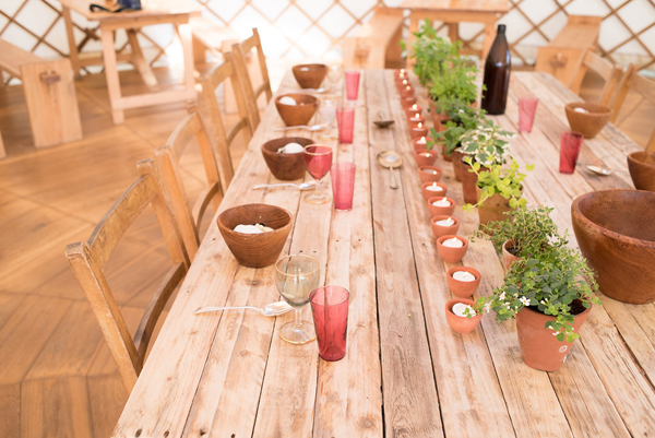 Rustic wedding trestle table with terracotta pots of herbs and tealights // Photography Captured by Katrina // Wedding Yurts // The Natural Wedding Company