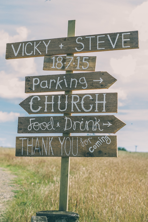 Rustic wooden direction sign for Vicky and Steve’s DIY Village Fete Wedding // Lucy Jane Photography // The Natural Wedding Company