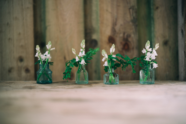 Vintage inkwells with spring flowers and ferns // Enchanted Brides Photography // The Natural Wedding Company