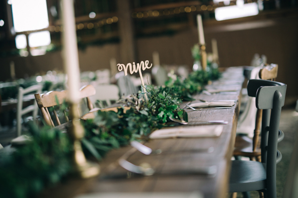 Gold wedding table numbers with greenery garland // Enchanted Brides Photography // The Natural Wedding Company