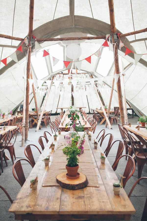 Tipi decorated with wildflowers // Emma Stoner Photography // The Natural Wedding Company