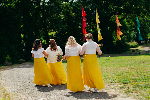 Bridesmaids in lace tops and yellow maxi skirts // Bohemian Weddings // The Natural Wedding Company