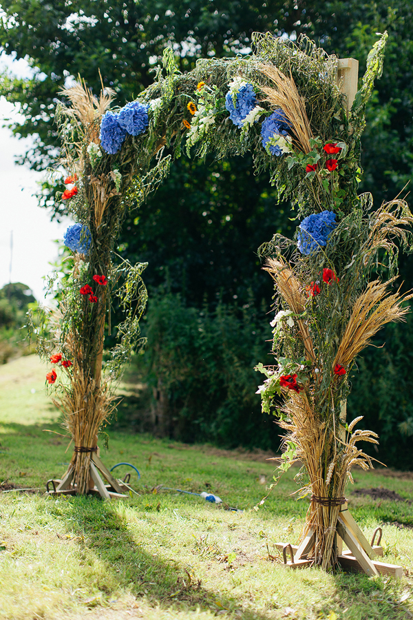 Floral arch with poppies and dried wheat // Bohemian Weddings // The Natural Wedding Company