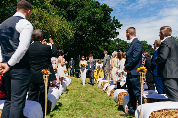 Hay bale seating at a meadow wedding ceremony // Bohemian Weddings // The Natural Wedding Company