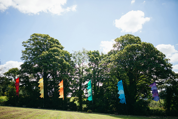 Rainbow festival wedding flags // Bohemian Weddings // The Natural Wedding Company