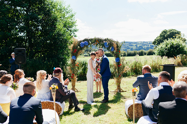 Outdoor meadow wedding ceremony with floral arch // Bohemian Weddings // The Natural Wedding Company