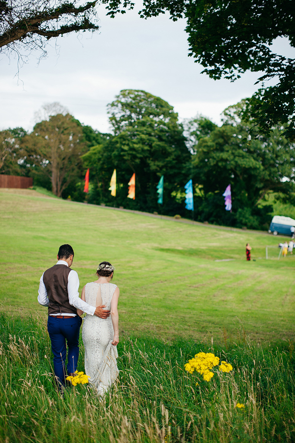 Bride and groom in festival meadow // Bohemian Weddings // The Natural Wedding Company