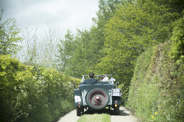 Bride and groom in vintage car along country lanes // Jennie Hill Photography // The Natural Wedding Company
