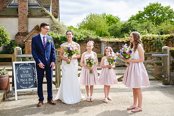 Bride and groom with bridesmaids - English country barn wedding // Warren & Carmen Photography // The Natural Wedding Company